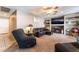 Cozy living room with fireplace, built in shelving, ceiling fan and plush carpet at 3661 Margarita Way, Las Vegas, NV 89103