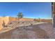 Landscaped backyard with desert-style gravel, plants, and a tall block wall for privacy at 494 Copper Falcon Ave, Henderson, NV 89011