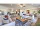 Bright and airy living room featuring neutral tones, modern decor, and seamless flow into the kitchen at 494 Copper Falcon Ave, Henderson, NV 89011