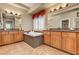 Bathroom featuring double sinks, bathtub, and granite counters at 519 Via Garofano Ave, Henderson, NV 89011