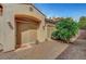 Home entrance featuring an arched overhang, desert landscaping, and covered access at 519 Via Garofano Ave, Henderson, NV 89011