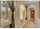 Bright hallway with tile flooring, arched doorway, and views of the front yard at 519 Via Garofano Ave, Henderson, NV 89011
