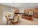 Open kitchen and dining area with granite counters and stainless steel appliances at 519 Via Garofano Ave, Henderson, NV 89011