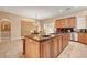Spacious kitchen island boasts a cooktop, sink, and granite countertops at 519 Via Garofano Ave, Henderson, NV 89011