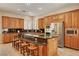 Gourmet kitchen featuring granite countertops, a center island, and stainless steel appliances at 519 Via Garofano Ave, Henderson, NV 89011
