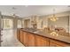 Gourmet kitchen with granite counters, central island and stainless appliances, flows into dining & living rooms at 519 Via Garofano Ave, Henderson, NV 89011