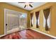 Sunlit living room featuring wood floors, sliding glass doors, and custom window treatments at 519 Via Garofano Ave, Henderson, NV 89011