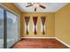 Cozy living room with hardwood floors, sliding glass door, and decorative curtains at 519 Via Garofano Ave, Henderson, NV 89011