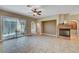 Cozy living room with a fireplace, tile flooring, and access to the patio at 519 Via Garofano Ave, Henderson, NV 89011