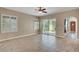 Neutral living space features tile floors, plantation shutters and a sliding glass door to the patio at 519 Via Garofano Ave, Henderson, NV 89011