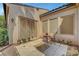 Charming patio area with stone tile, cafe table, and views of lush greenery at 519 Via Garofano Ave, Henderson, NV 89011