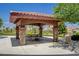 Community outdoor pavilion with a picnic table, stone pillars, and a desert view at 519 Via Garofano Ave, Henderson, NV 89011