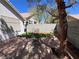 Backyard with stone patio, artificial grass, and lush landscape, perfect for outdoor entertaining at 5554 Chicory Falls Ct, Las Vegas, NV 89148