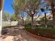 This backyard features mature landscaping, a brick patio, and an ornamental fountain at 5554 Chicory Falls Ct, Las Vegas, NV 89148