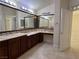 Bathroom featuring dual sinks, a makeup vanity, and a decorative backsplash at 5554 Chicory Falls Ct, Las Vegas, NV 89148