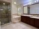 Elegant bathroom with a glass-enclosed shower, soaking tub, and dual sink vanity at 5554 Chicory Falls Ct, Las Vegas, NV 89148