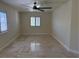 This empty bedroom features tile flooring, recessed lighting, a ceiling fan, and a window with shutters at 5554 Chicory Falls Ct, Las Vegas, NV 89148