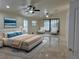 Bright and spacious bedroom featuring tile floors, recessed lighting, and a cozy seating area at 5554 Chicory Falls Ct, Las Vegas, NV 89148