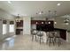 Spacious kitchen featuring granite countertops, center island with bar stool seating, and modern fixtures at 5554 Chicory Falls Ct, Las Vegas, NV 89148