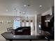 Open concept kitchen offering sleek countertops, island seating, stainless steel appliances, and recessed lighting at 5554 Chicory Falls Ct, Las Vegas, NV 89148