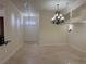 Open-concept living space with classic chandelier and neutral color palette at 5554 Chicory Falls Ct, Las Vegas, NV 89148