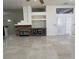 Spacious living room featuring tile flooring, a modern fireplace, and access to other living spaces at 5554 Chicory Falls Ct, Las Vegas, NV 89148