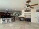Open-concept living space features a fireplace, bar seating and lots of space at 5554 Chicory Falls Ct, Las Vegas, NV 89148