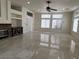 Open living room with tile flooring, recessed lighting, a stone fireplace, and large windows for natural light at 5554 Chicory Falls Ct, Las Vegas, NV 89148