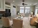 Inviting living room featuring tile flooring, a stone fireplace, neutral decor, and natural light from large windows at 5554 Chicory Falls Ct, Las Vegas, NV 89148