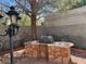 Backyard with a stone outdoor kitchen featuring a sink and BBQ, perfect for entertaining at 5554 Chicory Falls Ct, Las Vegas, NV 89148