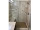 This bathroom features a large glass shower with tile surround, a seat, and a hand-held shower head at 5554 Chicory Falls Ct, Las Vegas, NV 89148