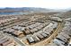 An aerial view shows a well planned housing development near a lake and mountains at 59 Desert Ivy Ln, Henderson, NV 89011