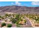 Aerial view of homes in a desert community nestled against a mountain range at 59 Desert Ivy Ln, Henderson, NV 89011