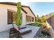 The backyard of this home features stone landscaping, chairs, and artificial turf at 59 Desert Ivy Ln, Henderson, NV 89011