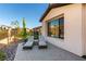 A backyard features a sitting area with two lounge chairs and manicured landscaping at 59 Desert Ivy Ln, Henderson, NV 89011