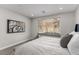 Comfortable bedroom featuring a modern design, large window and views of the landscaped backyard at 59 Desert Ivy Ln, Henderson, NV 89011