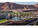 Upscale community pool area boasts palm trees, mountain views, and a desert landscape at 59 Desert Ivy Ln, Henderson, NV 89011
