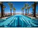 Lap pool with mountain view, surrounded by palms and lounge chairs at 59 Desert Ivy Ln, Henderson, NV 89011