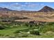 Scenic golf course view with green fairways, sand traps, and mountain views at 59 Desert Ivy Ln, Henderson, NV 89011