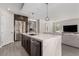 Kitchen with stainless appliances, a large center island with white marble countertops, and breakfast bar at 59 Desert Ivy Ln, Henderson, NV 89011