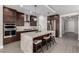 Bright kitchen with stainless steel appliances, a large island with bar seating, and custom cabinets at 59 Desert Ivy Ln, Henderson, NV 89011