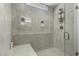 Contemporary walk-in shower with gray hexagon tile, glass enclosure and sleek fixtures at 59 Desert Ivy Ln, Henderson, NV 89011