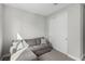 Neutral sitting area boasts plush gray sofa, large closet and carpet flooring at 59 Desert Ivy Ln, Henderson, NV 89011