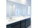 Modern bathroom with dual sinks, large mirror, and glass-enclosed shower at 600 N Carriage Hill Dr # 1019, Las Vegas, NV 89138