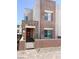 Modern two-story home with stone accents and a charming gated front yard at 600 N Carriage Hill Dr # 1019, Las Vegas, NV 89138