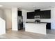 Modern kitchen featuring stainless steel appliances, a central island, and sleek black cabinetry at 600 N Carriage Hill Dr # 1019, Las Vegas, NV 89138