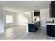 Spacious kitchen that opens into the living room, with an island, stainless appliances and hardwood floors at 600 N Carriage Hill Dr # 1019, Las Vegas, NV 89138