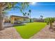 Enjoy the landscaped backyard with the covered patio and artificial grass at 6520 Ouida Way, Las Vegas, NV 89108