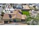 Backyard featuring low maintenance synthetic grass, desert landscaping, and a covered patio at 6520 Ouida Way, Las Vegas, NV 89108