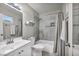 Bathroom features a shower over tub and a white vanity with a mirror at 6520 Ouida Way, Las Vegas, NV 89108